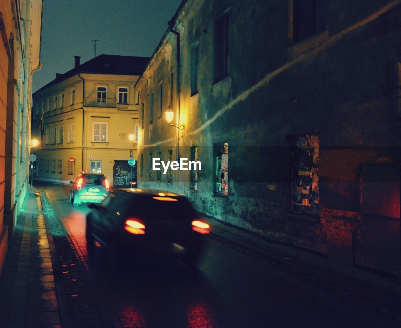 VIEW OF CITY STREET AT NIGHT