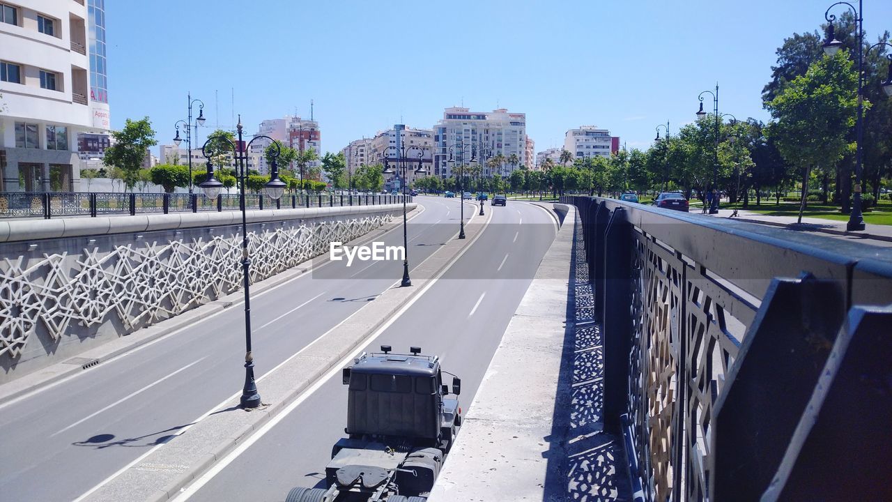 PANORAMIC VIEW OF CITY STREET AGAINST SKY