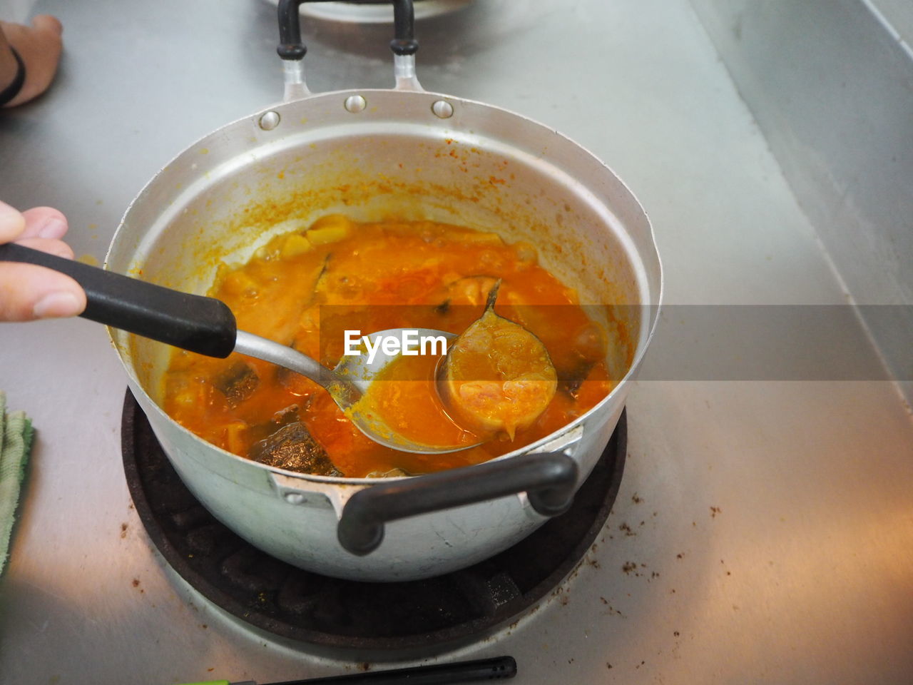 High angle view of person preparing food in cooking pan