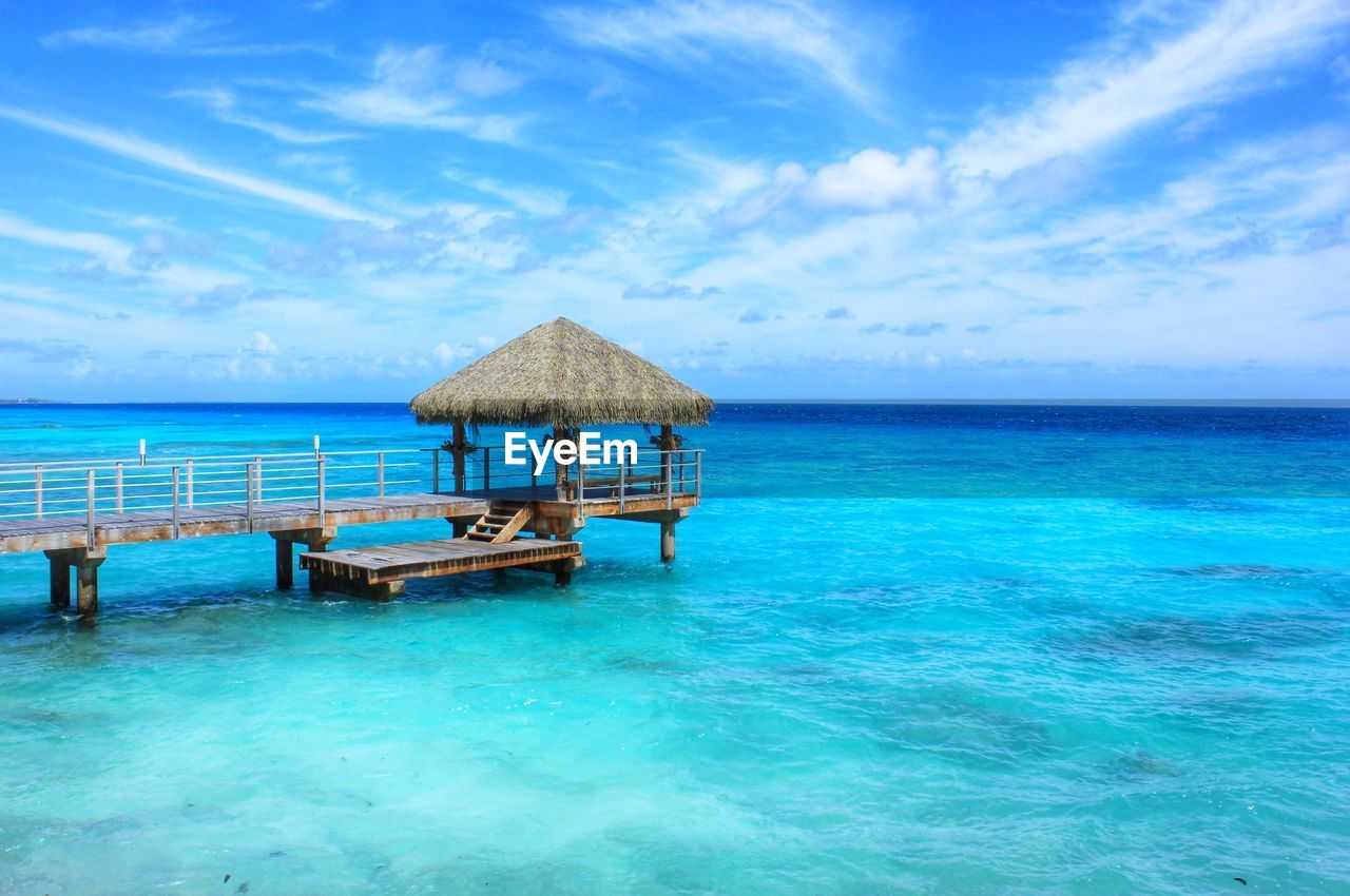 Scenic view of calm sea against cloudy sky