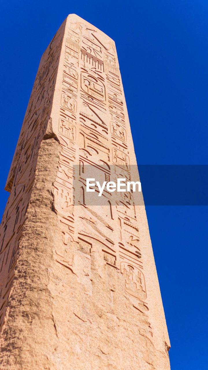 low angle view of old ruins against clear blue sky