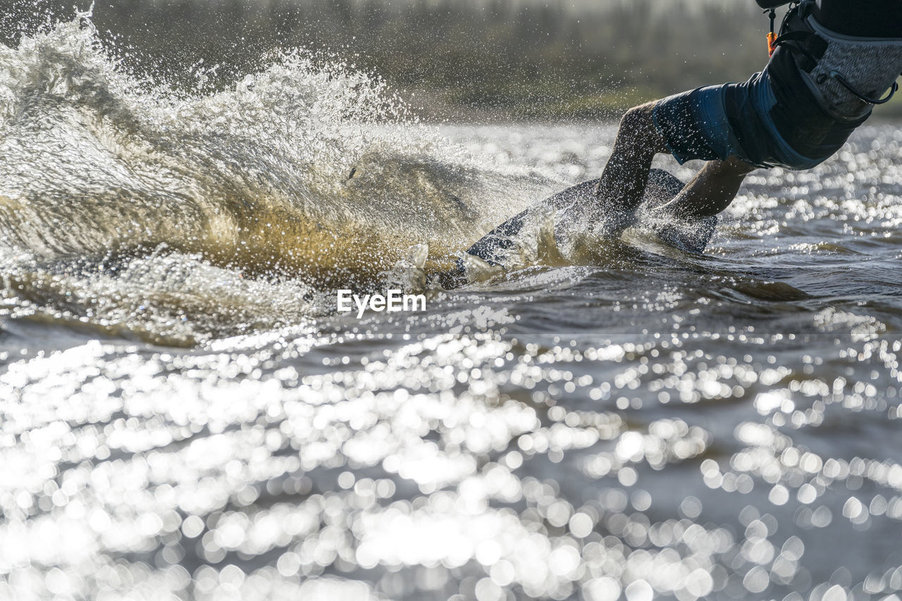 Waist-down male athlete kiteboarding in la ventana, mexico