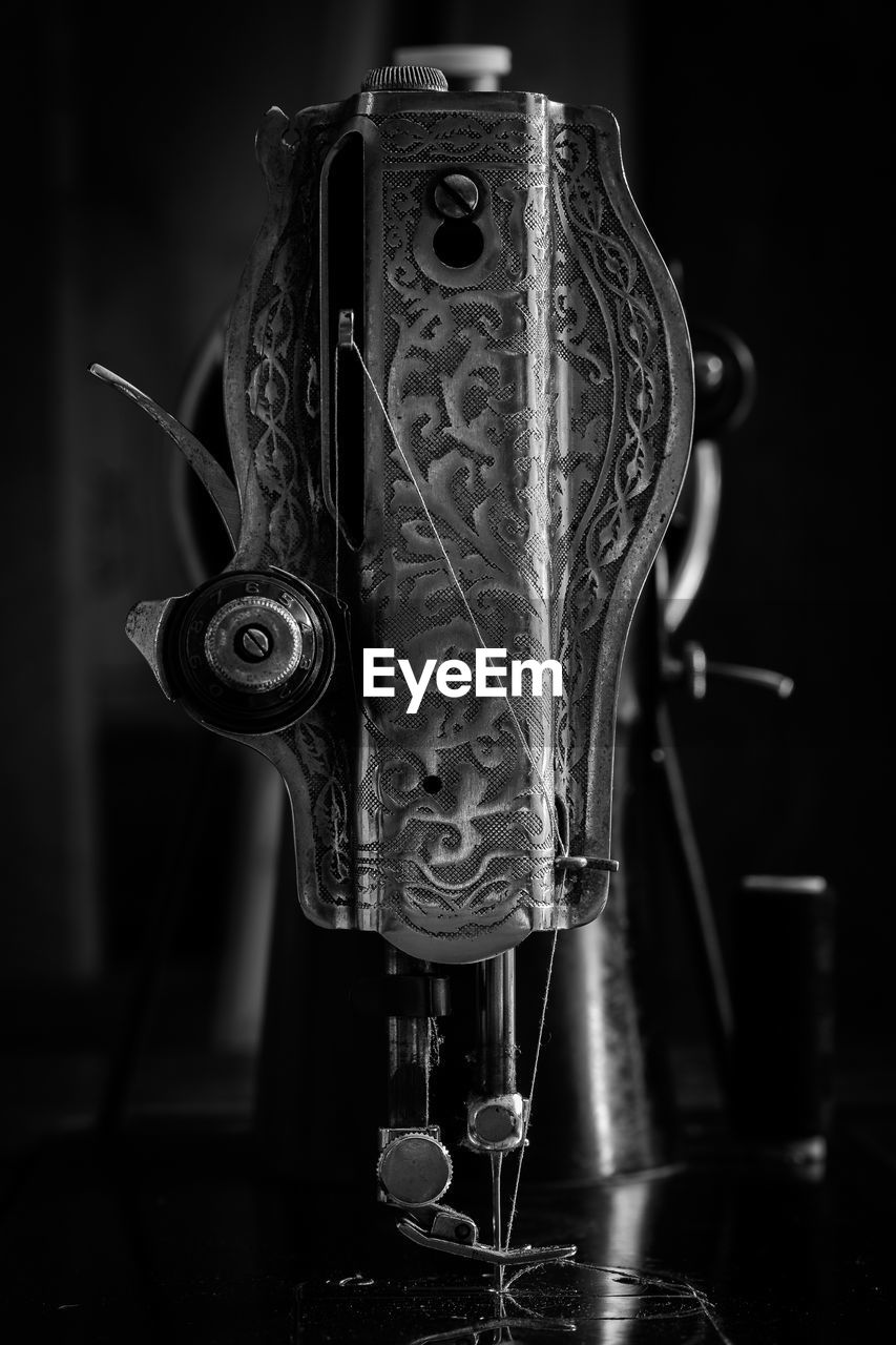 Close-up of sewing machine on table