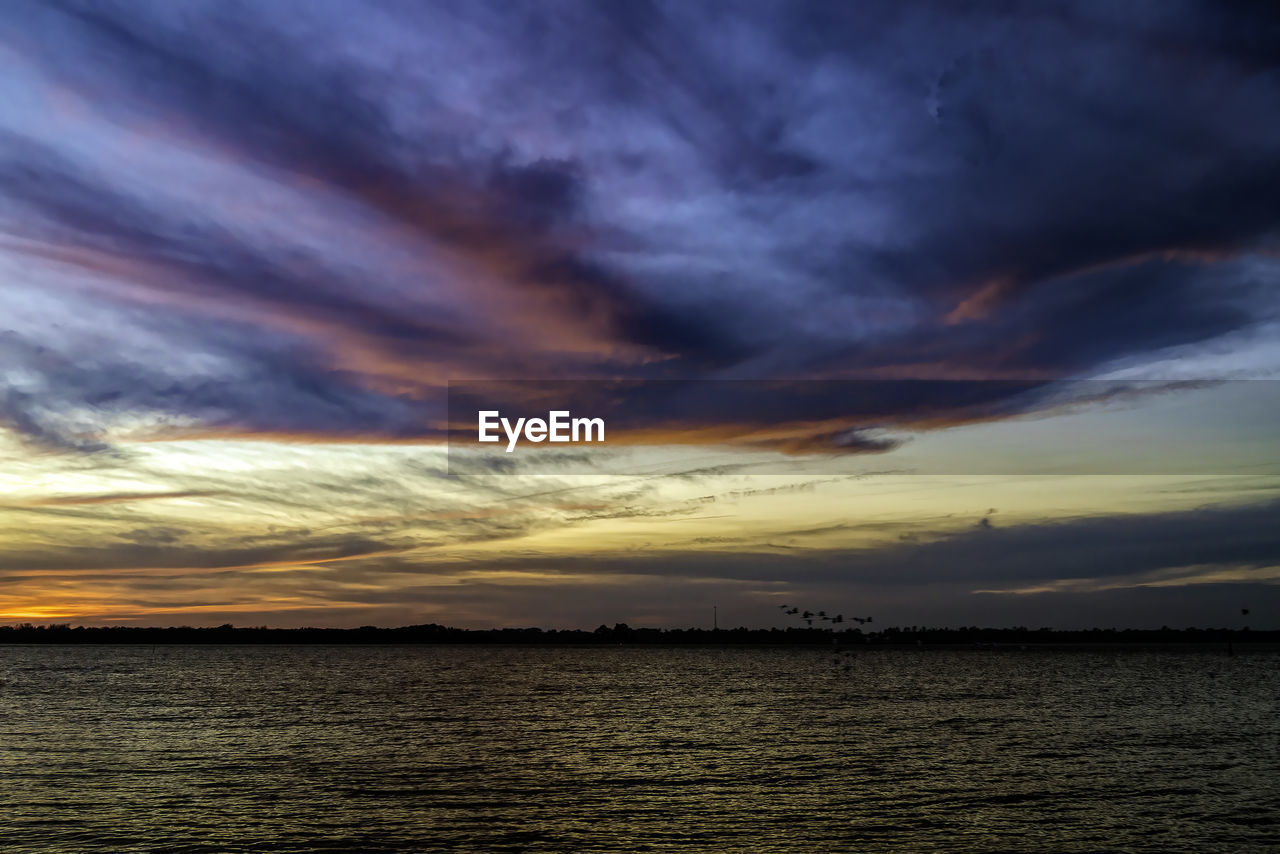 sky, cloud, water, sunset, beauty in nature, sea, dramatic sky, scenics - nature, nature, horizon, tranquility, ocean, tranquil scene, no people, afterglow, sunlight, environment, evening, cloudscape, coast, seascape, outdoors, dusk, storm, horizon over water, reflection, idyllic, landscape, wave, beach, moody sky, land