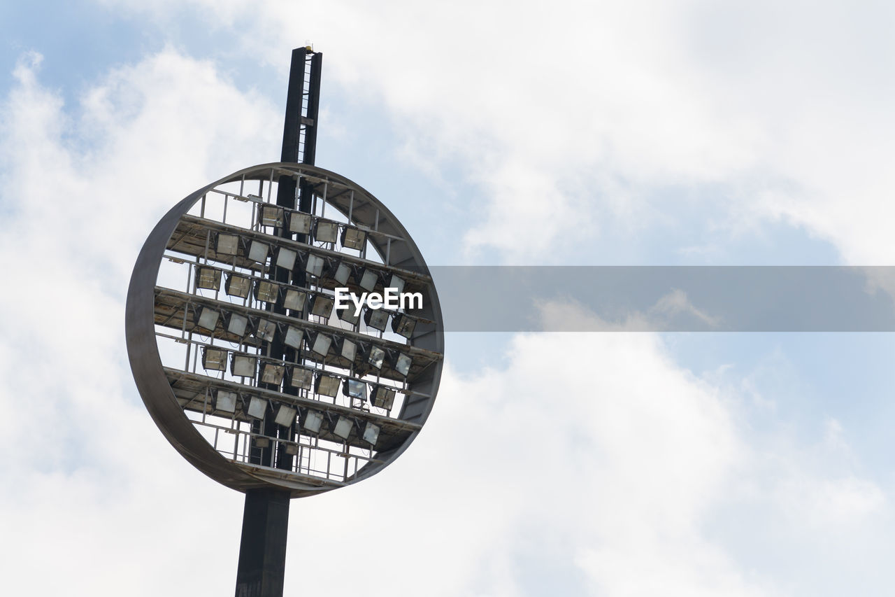 Low angle view of floodlights against sky