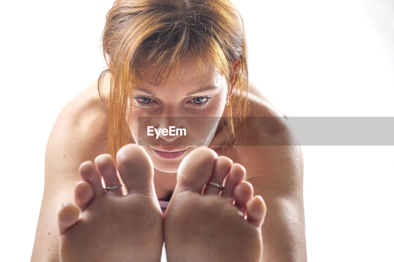 CLOSE-UP PORTRAIT OF YOUNG WOMAN WITH WHITE BACKGROUND