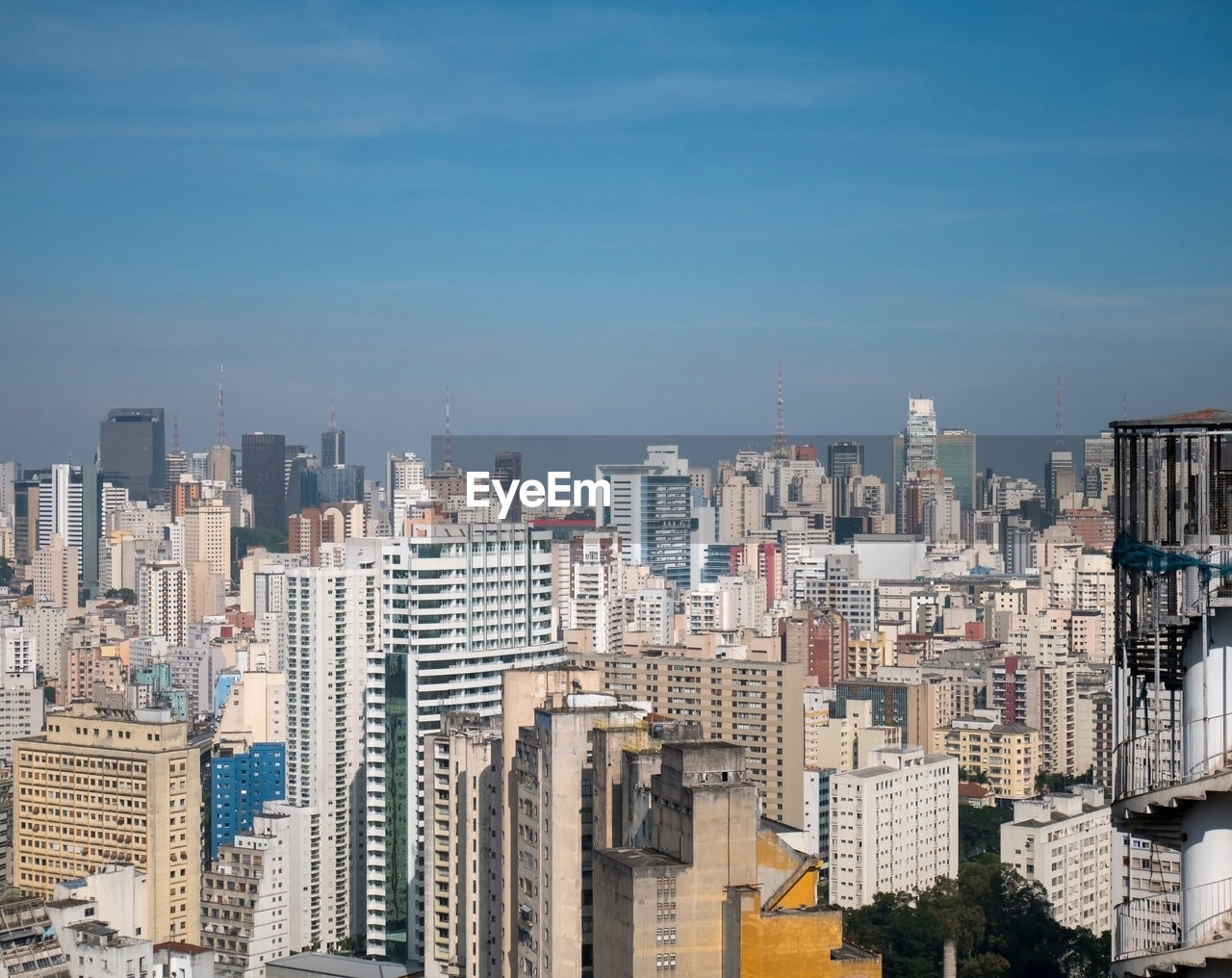 Aerial view of buildings in city against sky