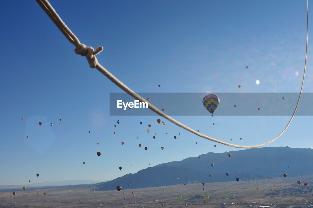 Hot air balloons flying against blue sky