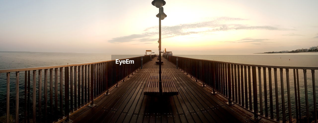 Wooden pier in protaras in cyprus at sunrise