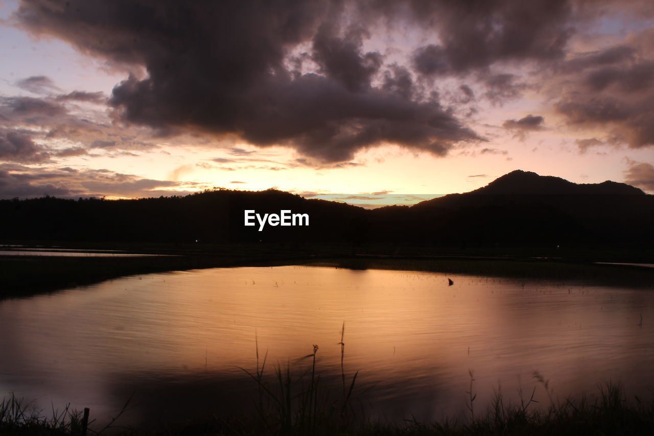 Scenic view of lake against sky during sunset