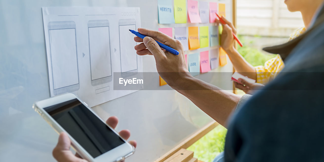 Cropped image of business colleagues working in office