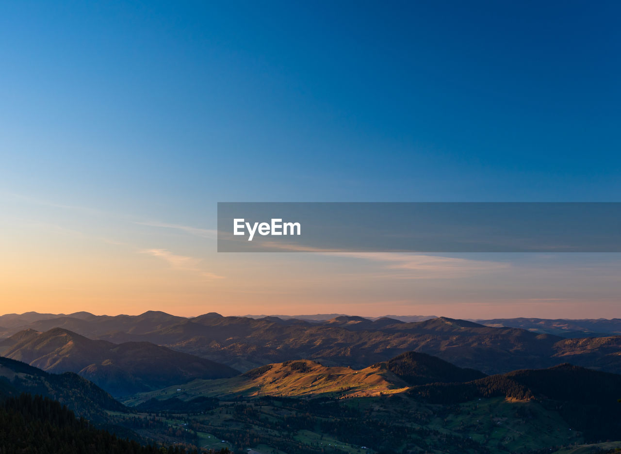 Scenic view of mountains against sky during sunset