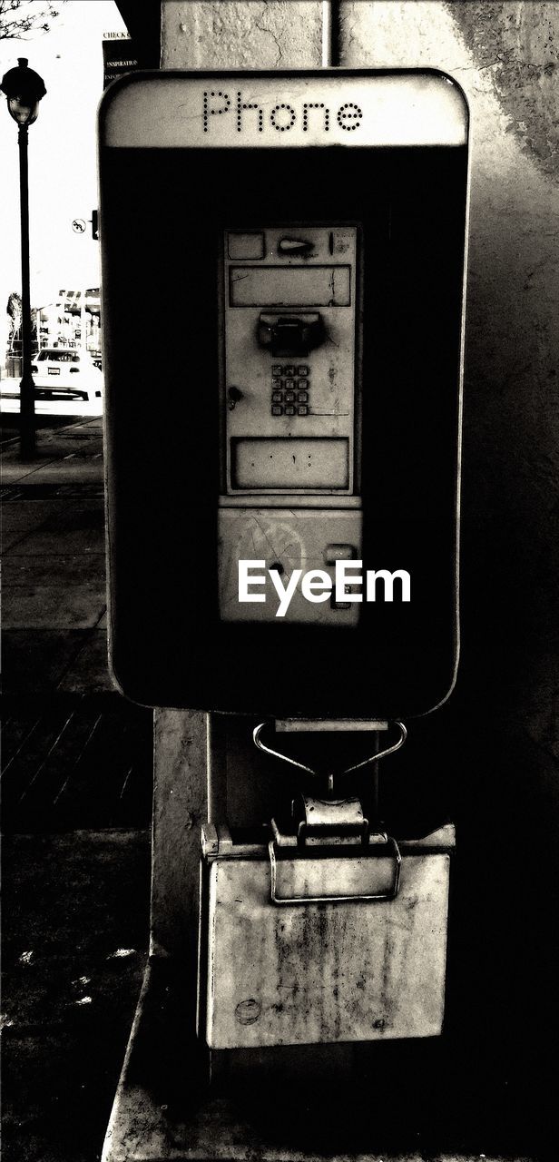 Close-up of an old pay phone outdoors