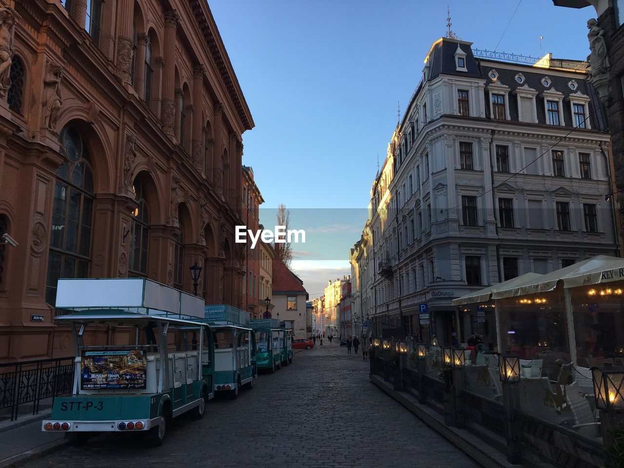 Street amidst buildings against sky in city