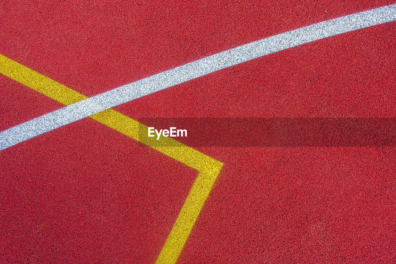 Colorful sports court background. top view to red and blue field rubber ground with  lines outdoors