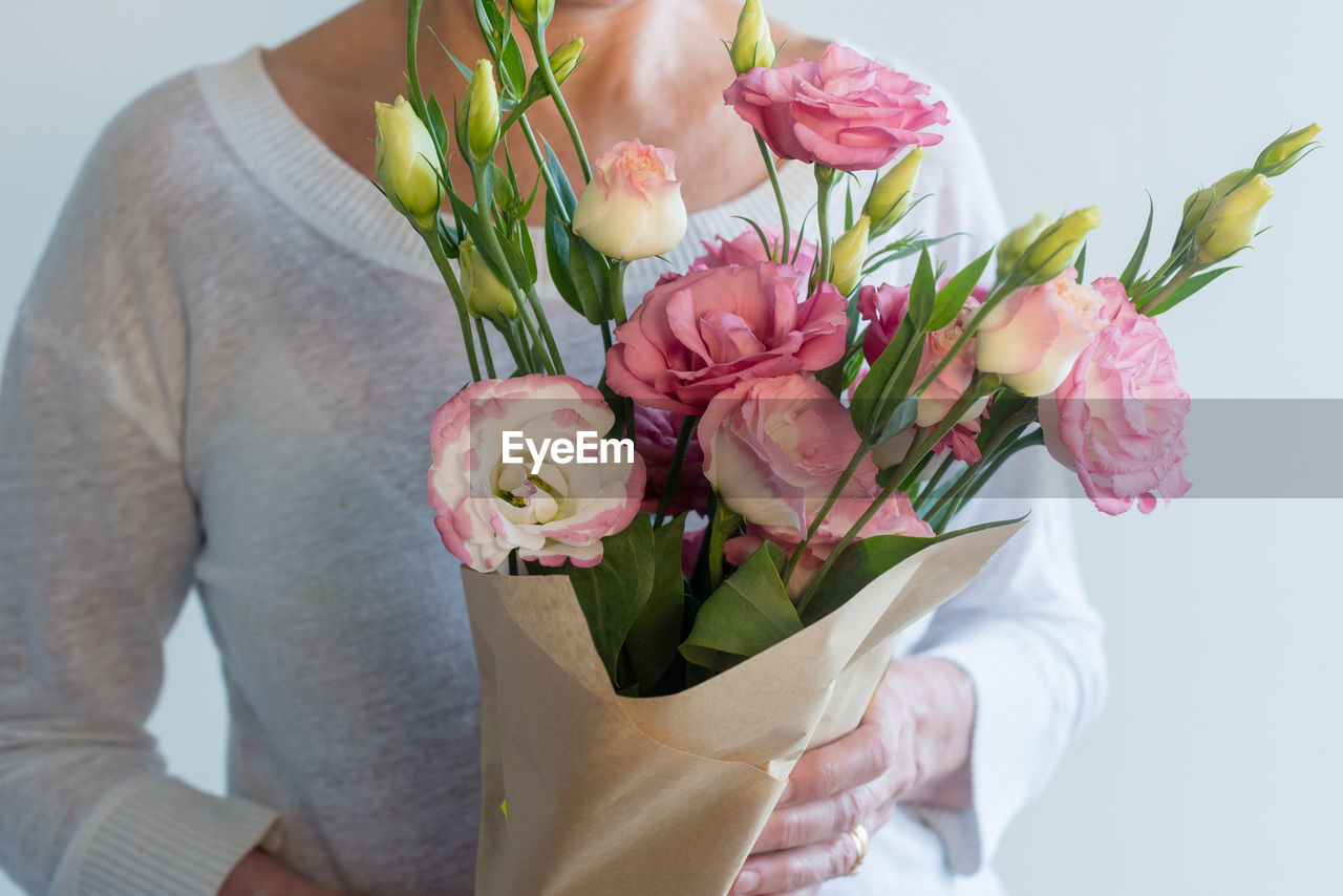 Woman holding bouquet of flowers