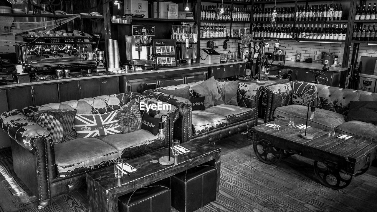 HIGH ANGLE VIEW OF EMPTY CHAIRS AND TABLE IN WAREHOUSE