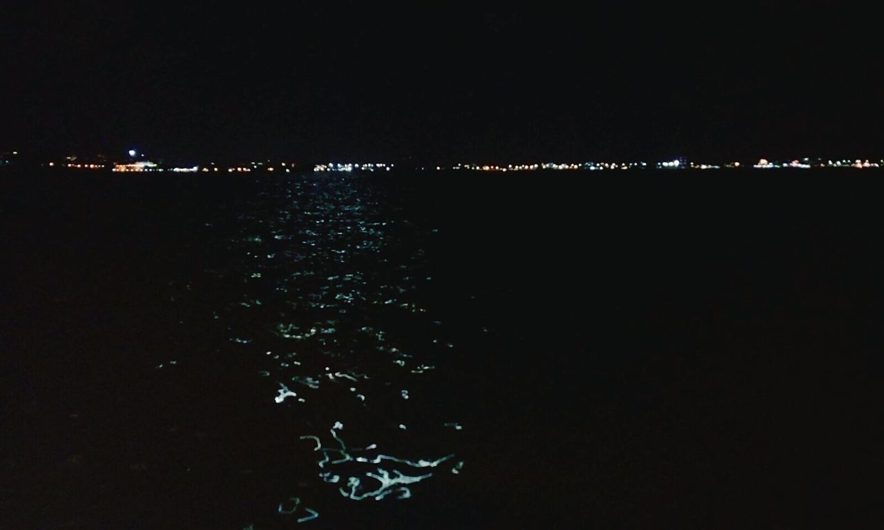 ILLUMINATED CITY AGAINST CLEAR SKY AT NIGHT