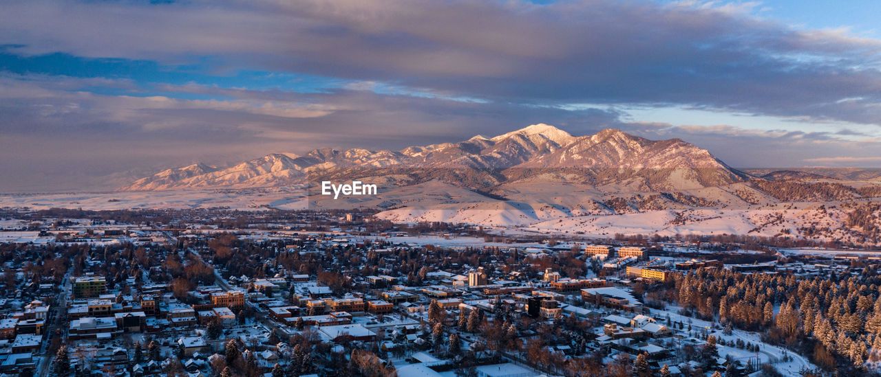 Drone view of the rockies next to the town of bozeman, montana in the middle of winter.