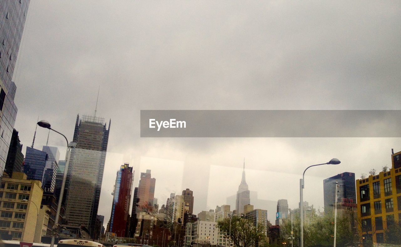 VIEW OF CITY AGAINST CLOUDY SKY