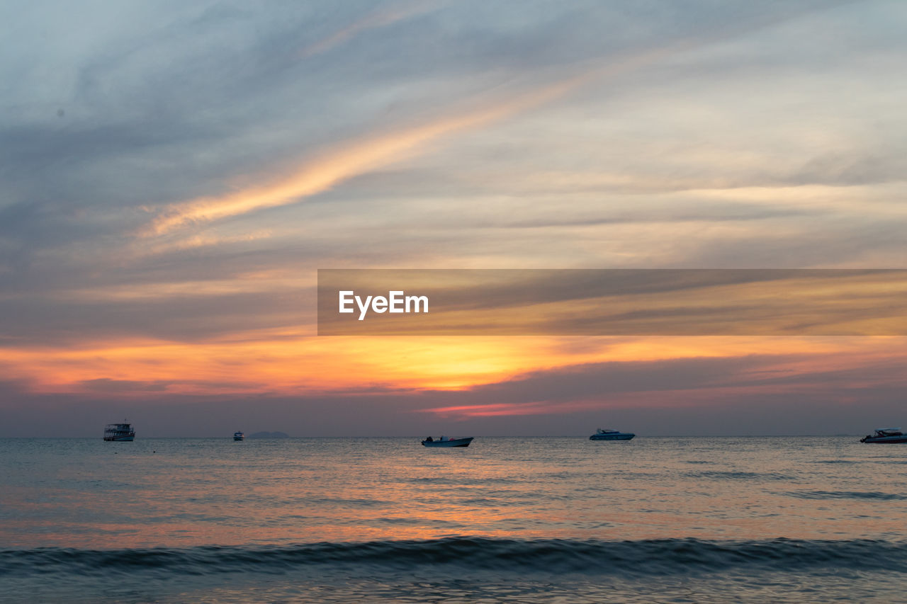 SCENIC VIEW OF SEA AGAINST ORANGE SKY DURING SUNSET