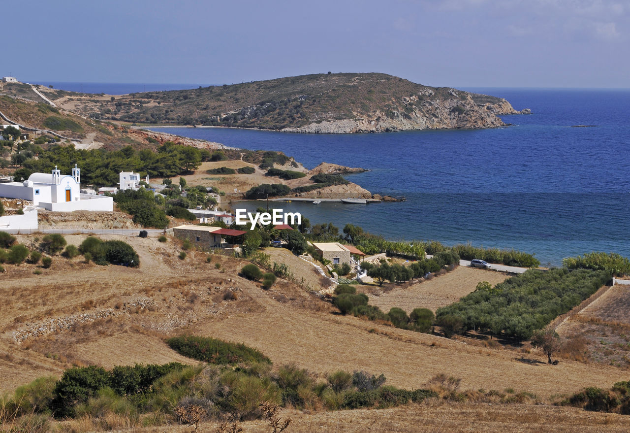 Scenic view of sea and mountains against clear sky