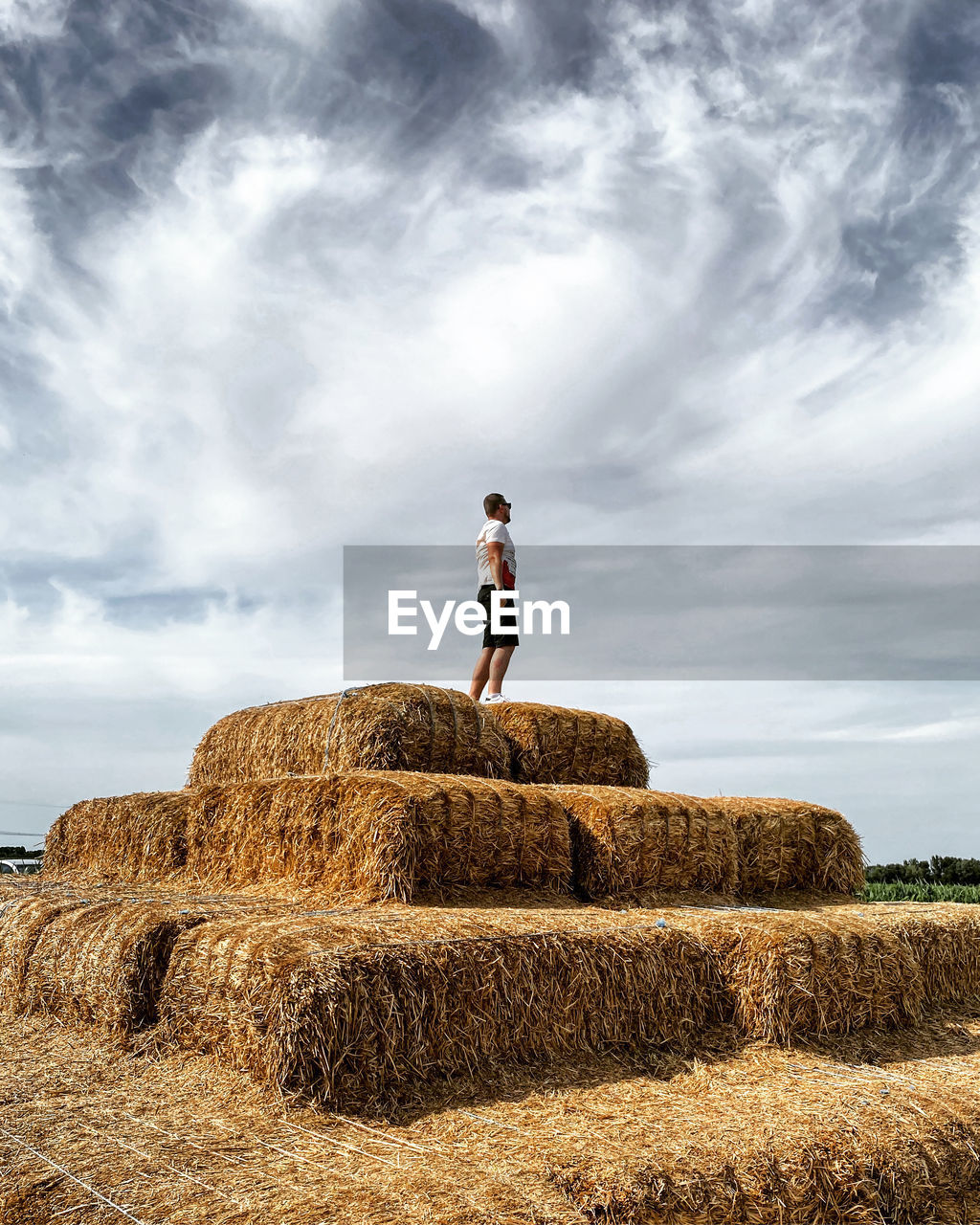 Full length of man standing on field against sky