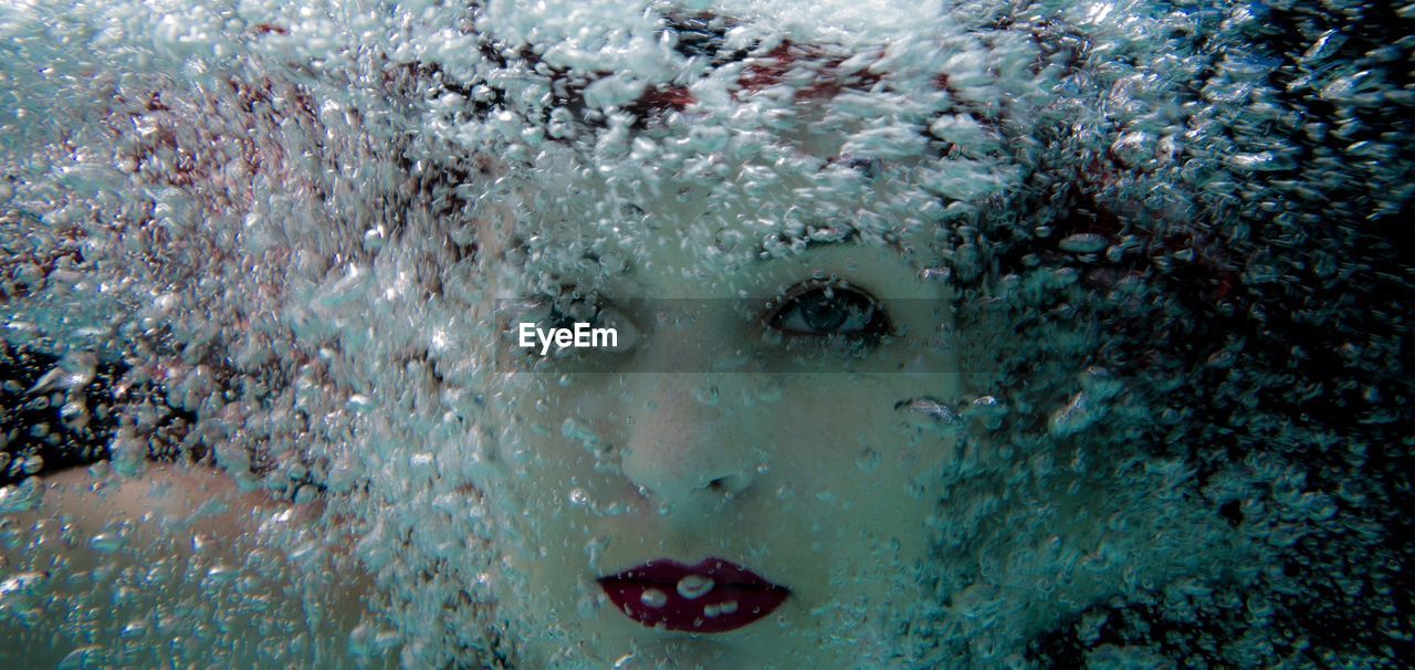 Close-up portrait of woman swimming in sea