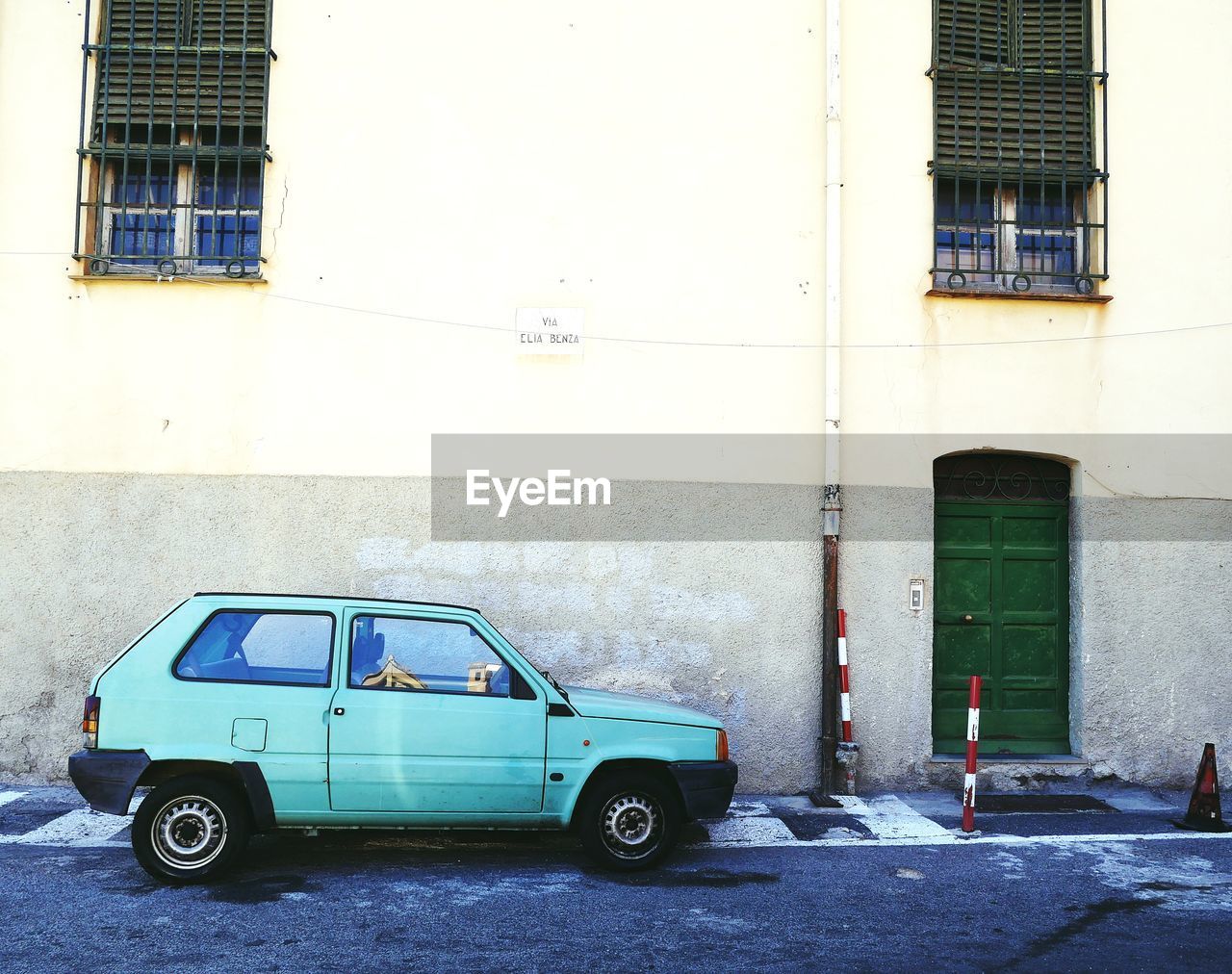 CAR PARKED AGAINST BUILDING