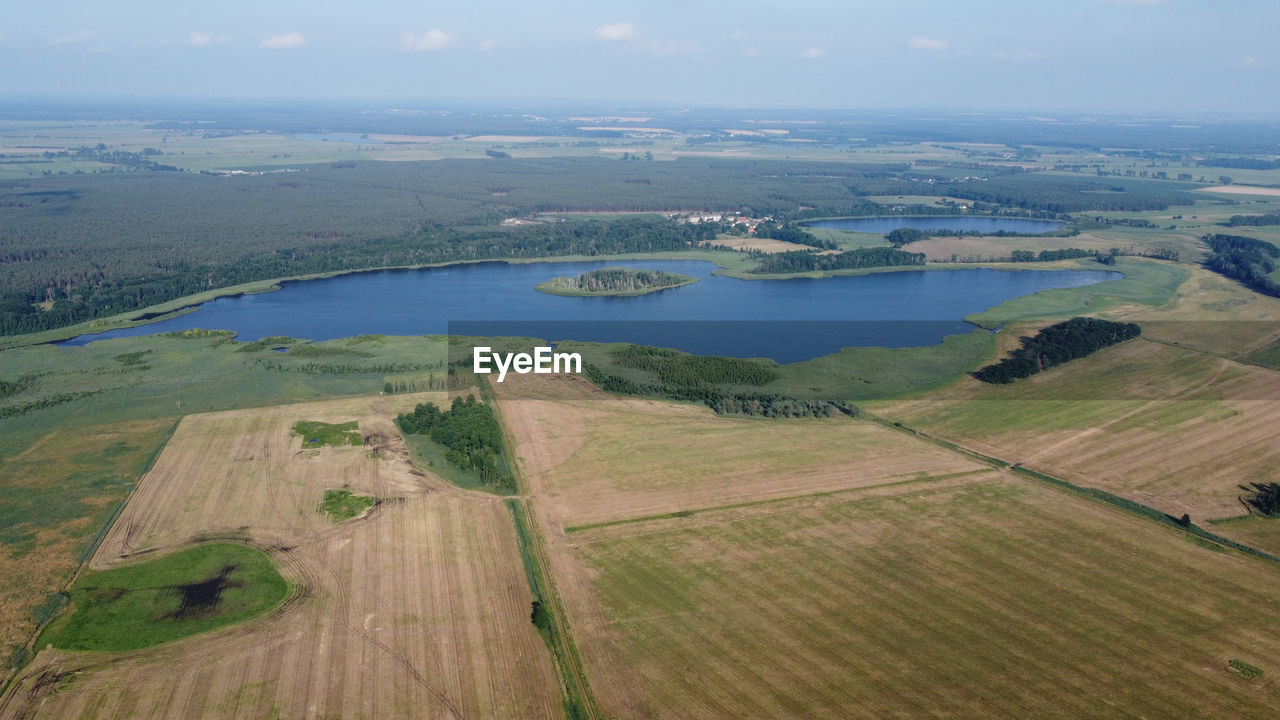 HIGH ANGLE VIEW OF LAND ON SHORE AGAINST SKY