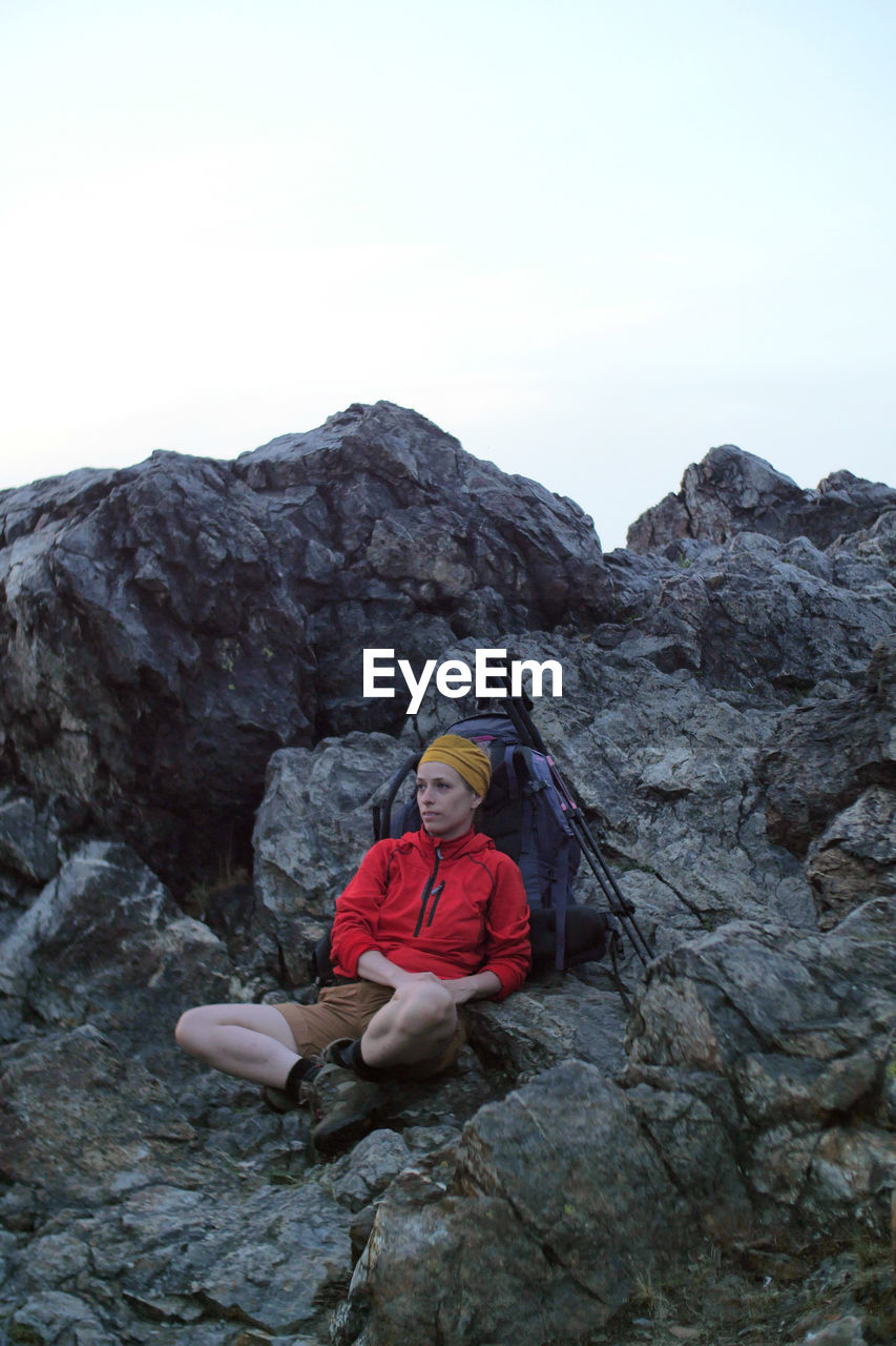 Full length of woman relaxing on rock formation