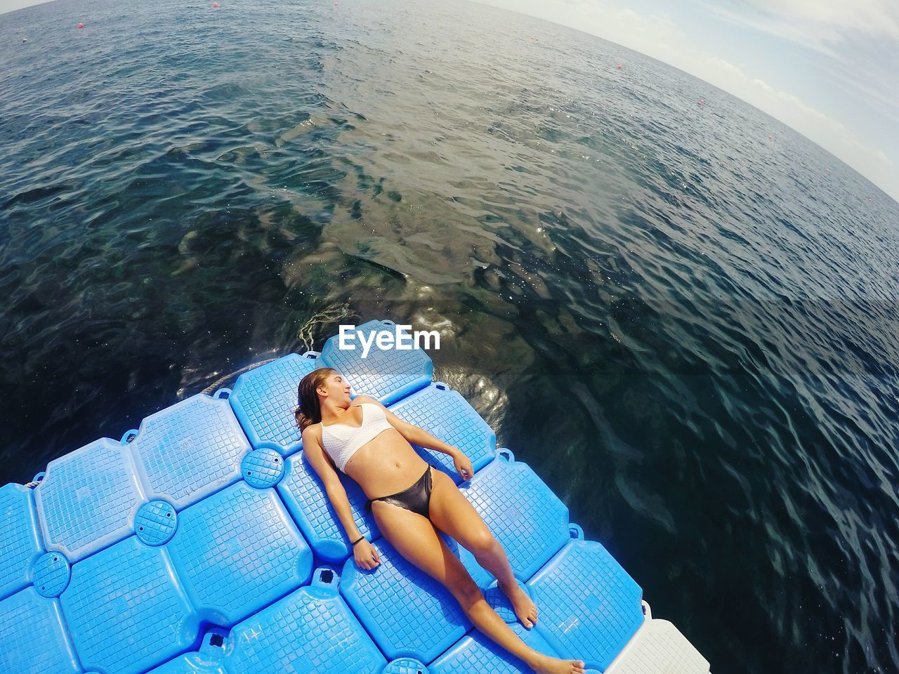 Woman relaxing on inflatable in sea