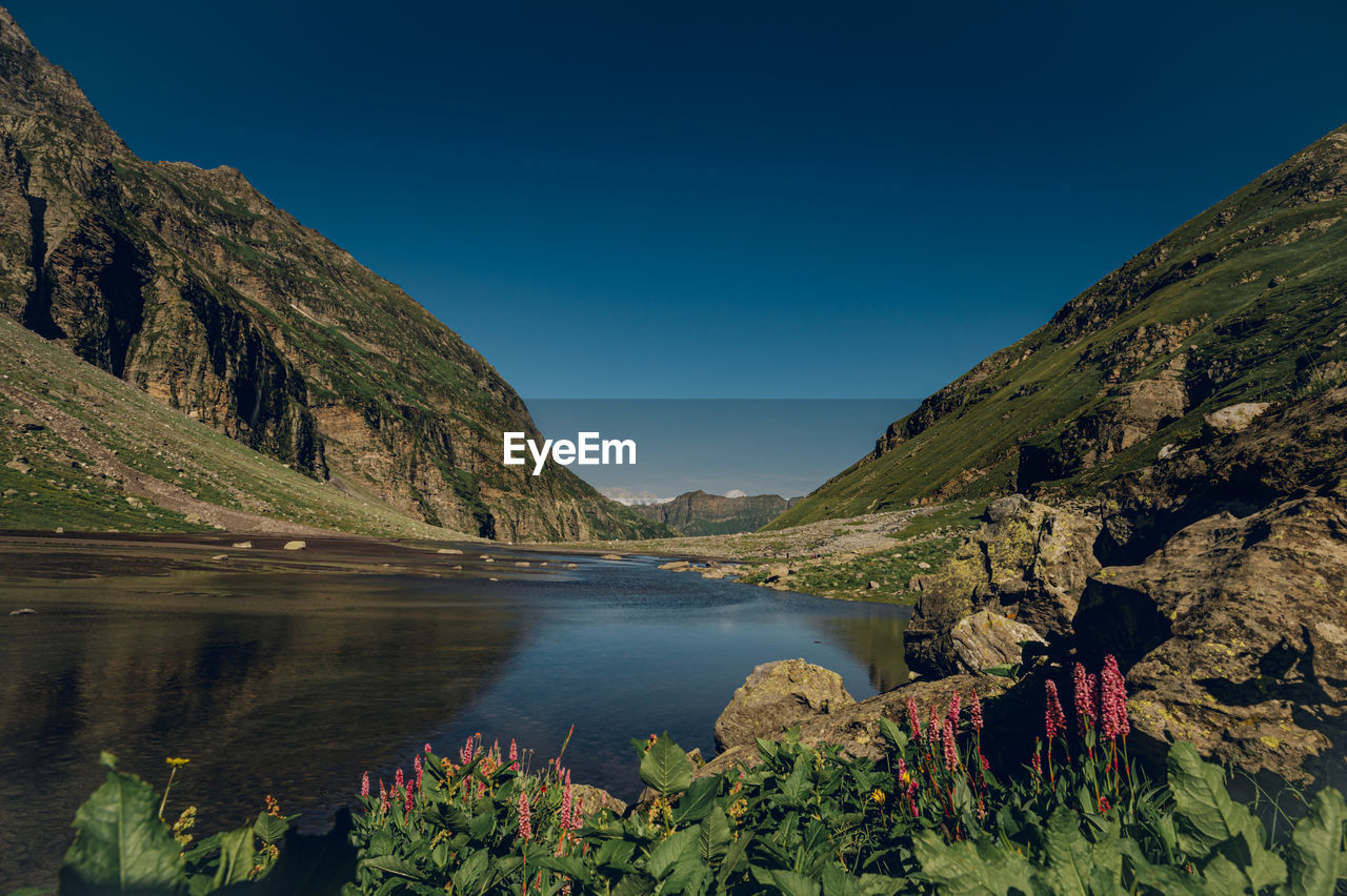 Scenic view of lake and mountains against sky