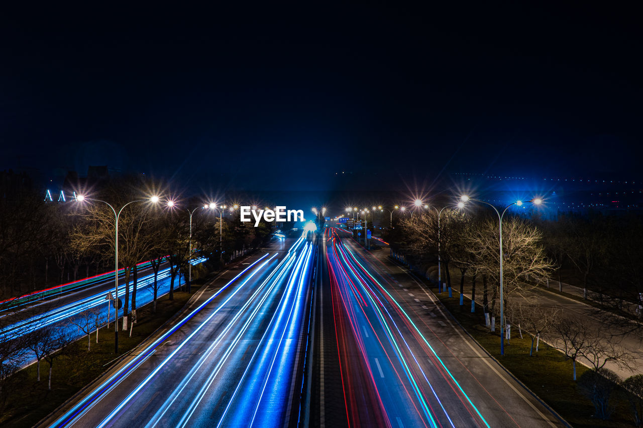 High angle view of light trails on road at night