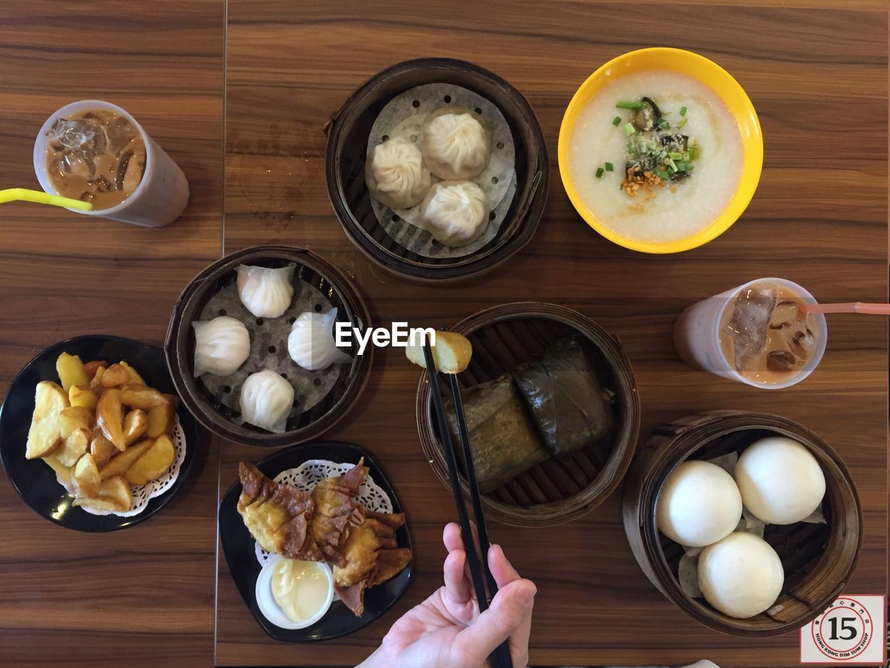 Cropped image of person having various food on restaurant table