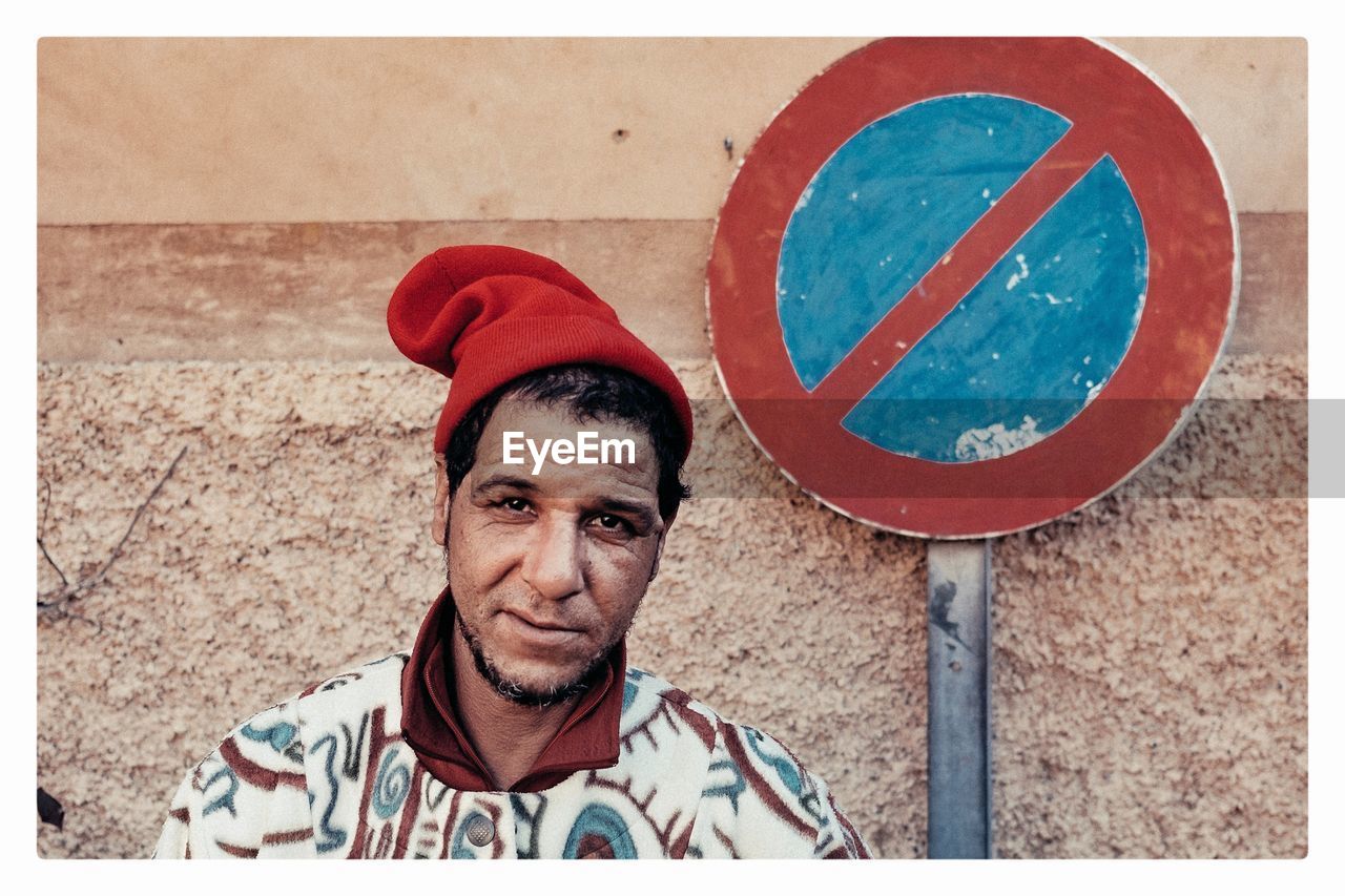 PORTRAIT OF MAN STANDING BY ROAD