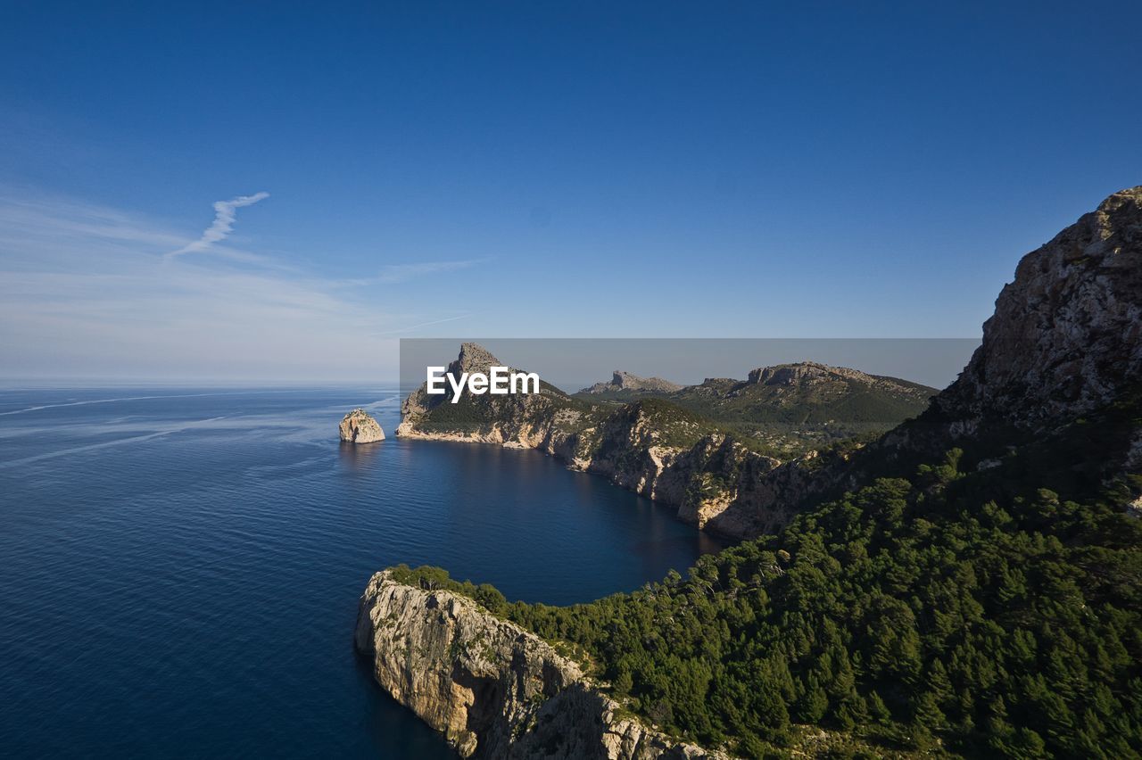 Scenic view of sea and mountains against sky