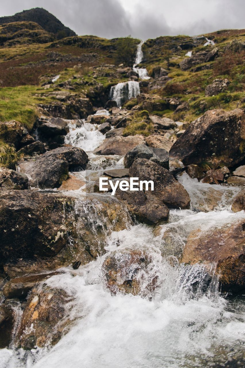 Scenic view of waterfall against sky