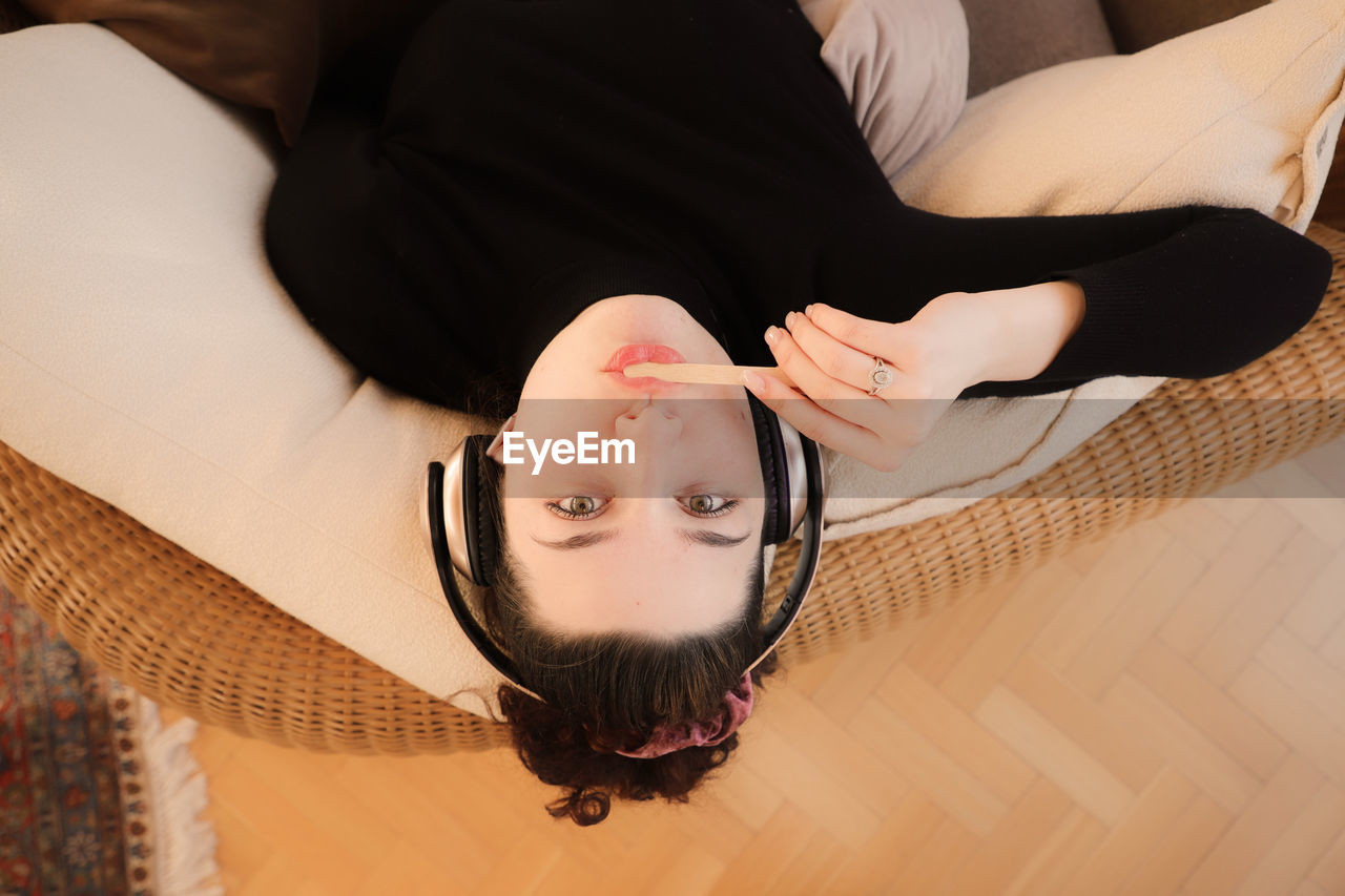 High angle portrait of woman lying down at home