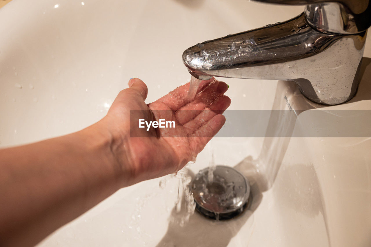 hand, sink, water, household equipment, faucet, washing, domestic room, cleaning, indoors, tap, home, glass, bathroom, hygiene, plumbing fixture, food, one person, adult, wet, motion, close-up, food and drink, domestic bathroom, washing hands, nature, drop, domestic kitchen, splashing, running water