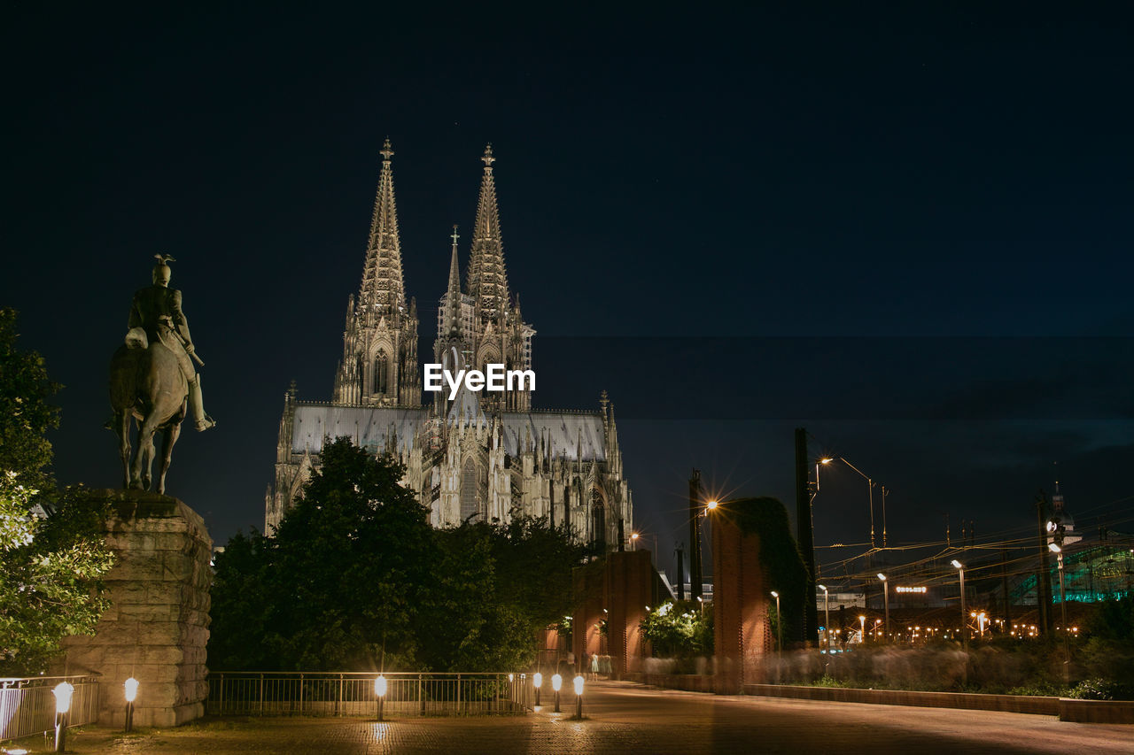 Cologne cathedral in illuminated city against sky