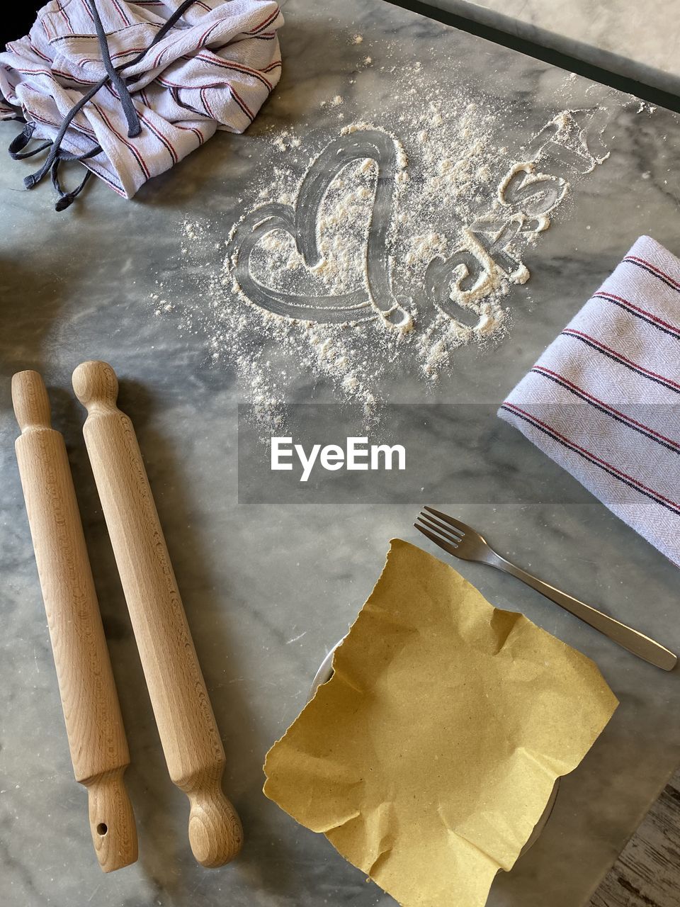 Pasta with love in high angle with heart written in flour 