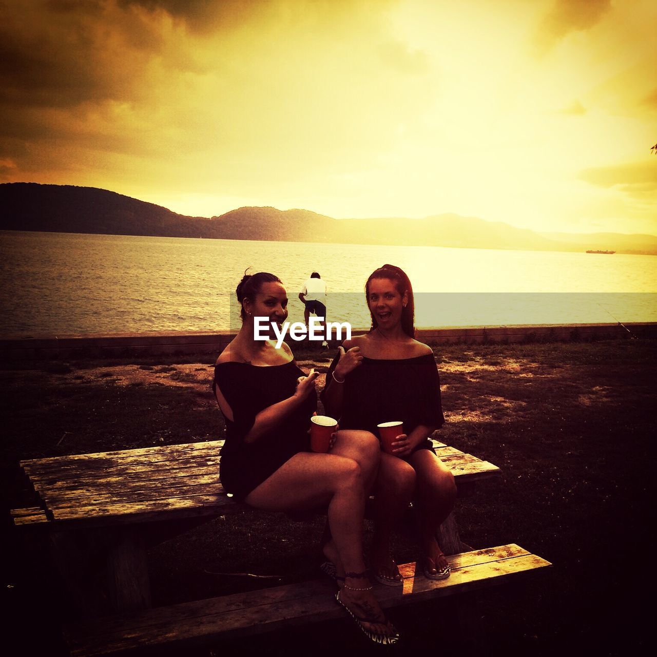 WOMAN SITTING ON BEACH