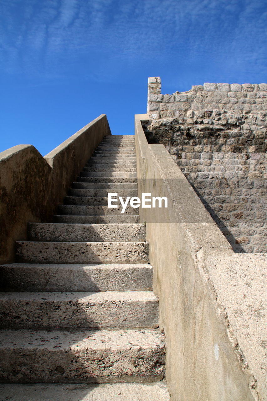 architecture, staircase, wall, steps and staircases, history, built structure, the past, sky, ancient history, ancient, nature, ruins, travel destinations, travel, stone material, fort, fortification, no people, blue, building exterior, stairs, surrounding wall, rock, temple, outdoors, the way forward, wall - building feature, tourism, fortified wall, building, old, day, clear sky, old ruin, sunlight, stone wall, sunny, ancient civilization, archaeological site