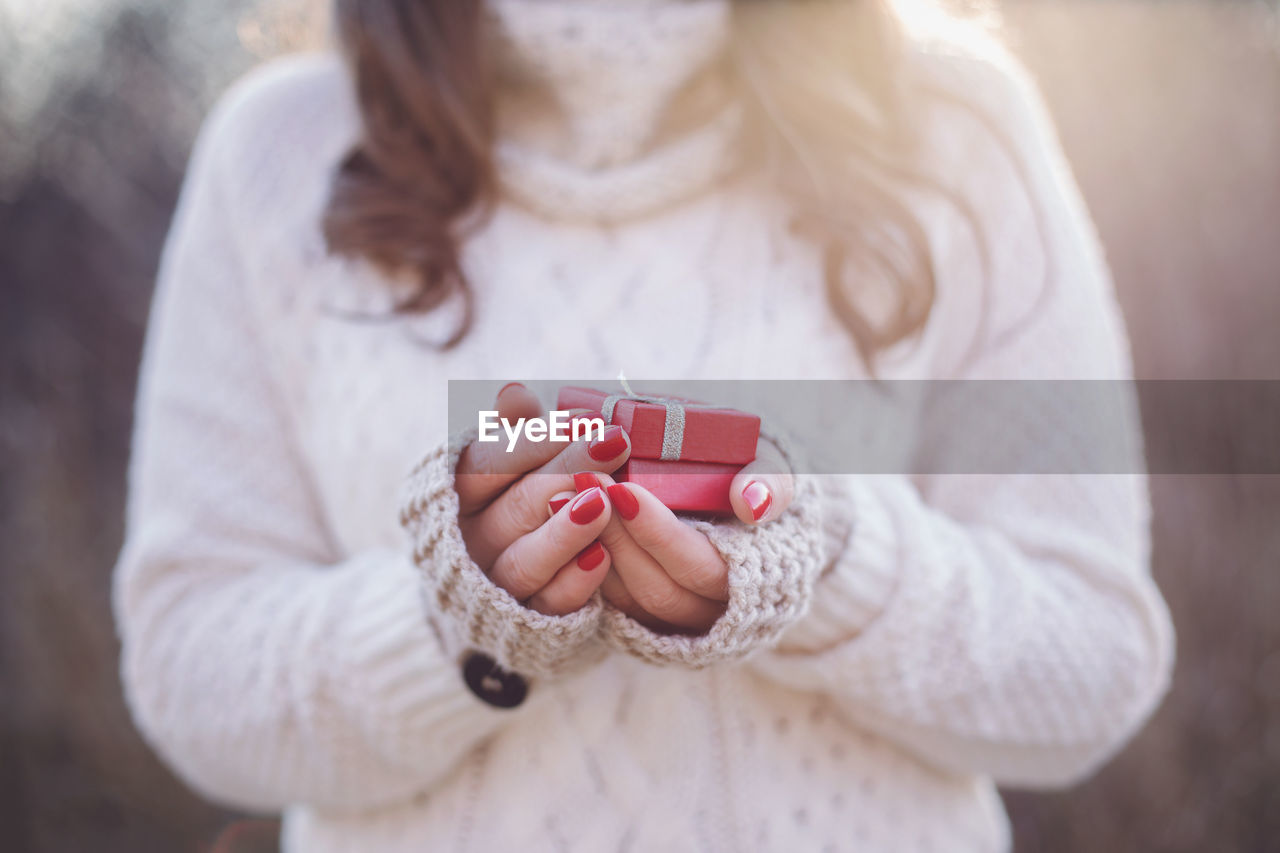 Midsection of woman holding gifts