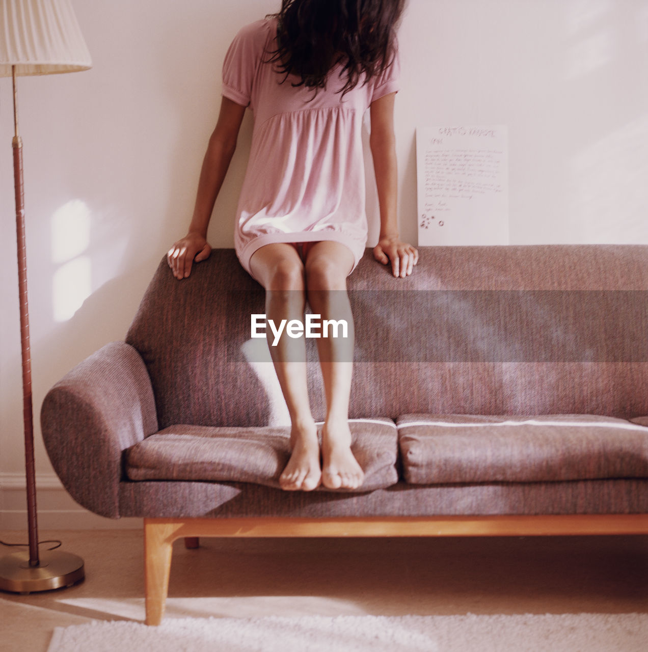 Teen girl sitting on sofa