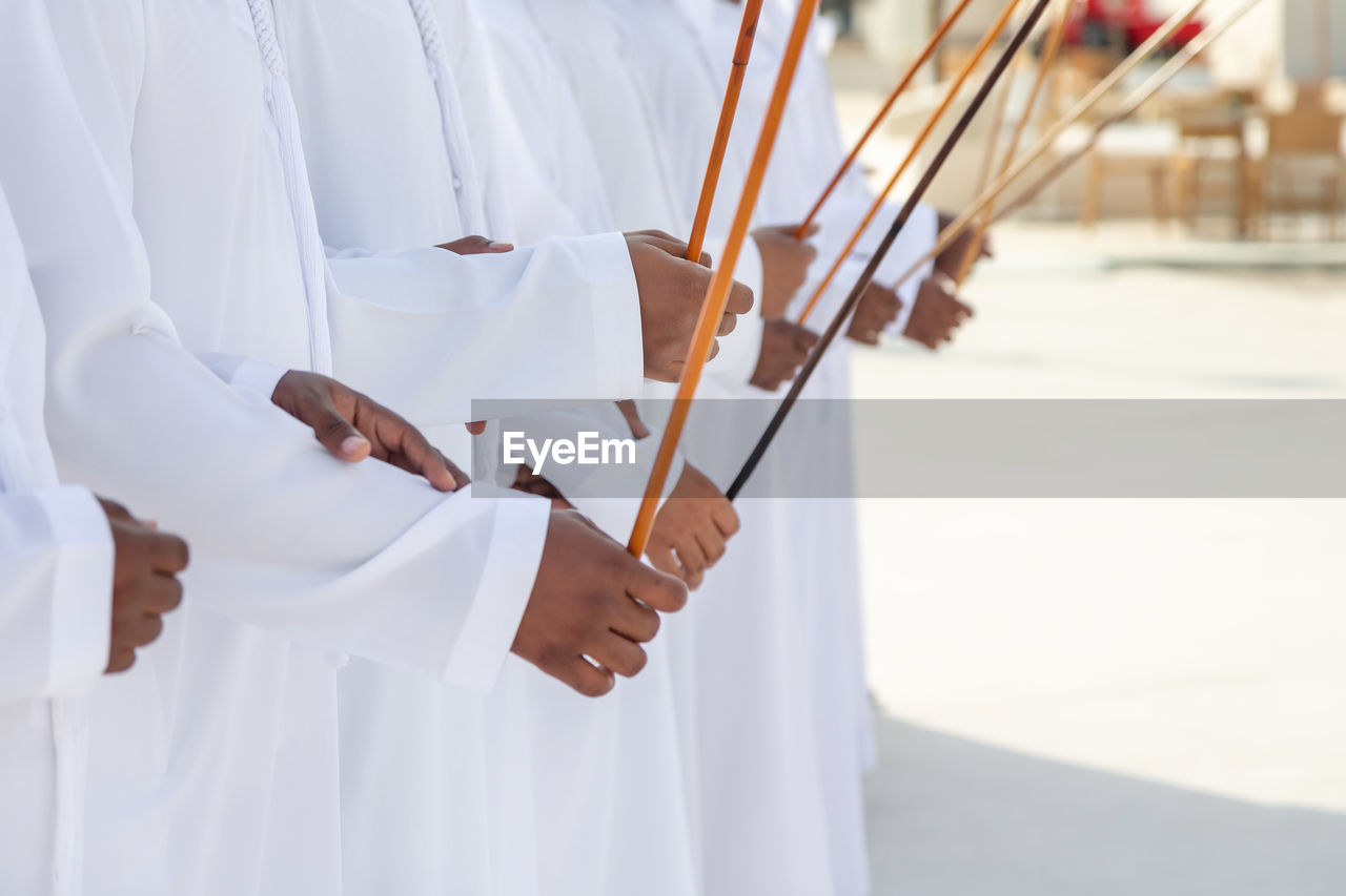 Traditional emirati al ayalah male dance, uae heritage, hands in frame