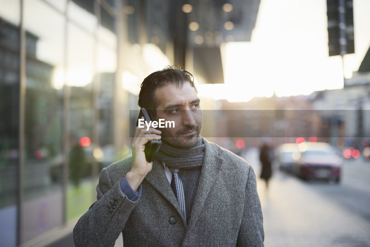 Businessman talking on phone outdoors