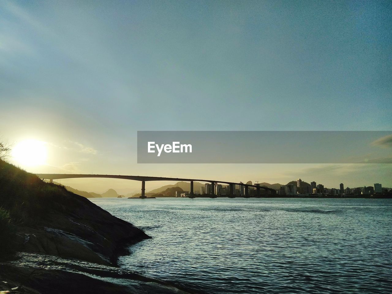 Bridge over river at sunset