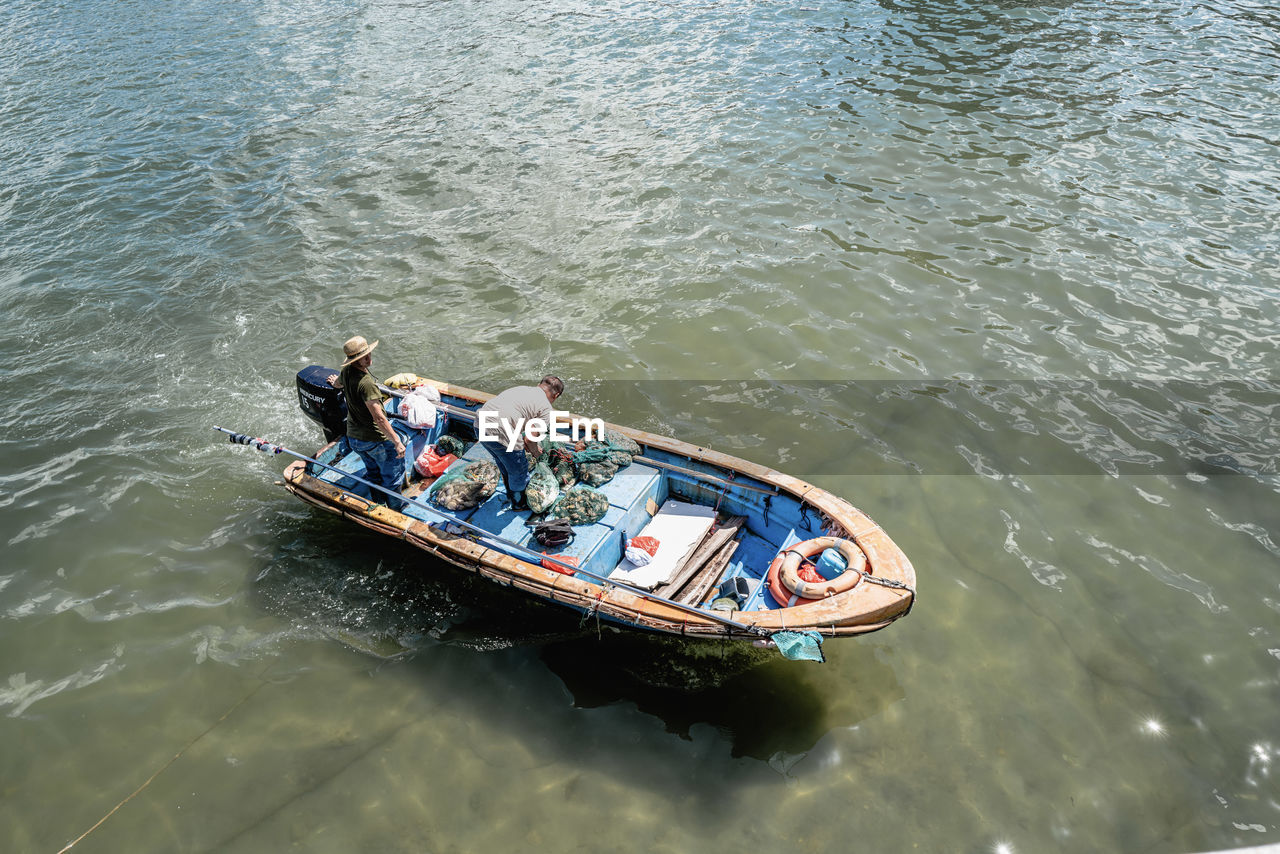 High angle view of people in boat at sea